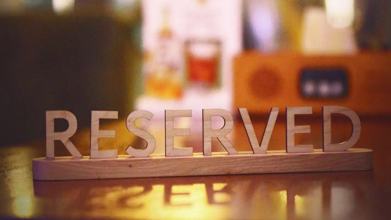 a wooden block that says reserved sitting on a table